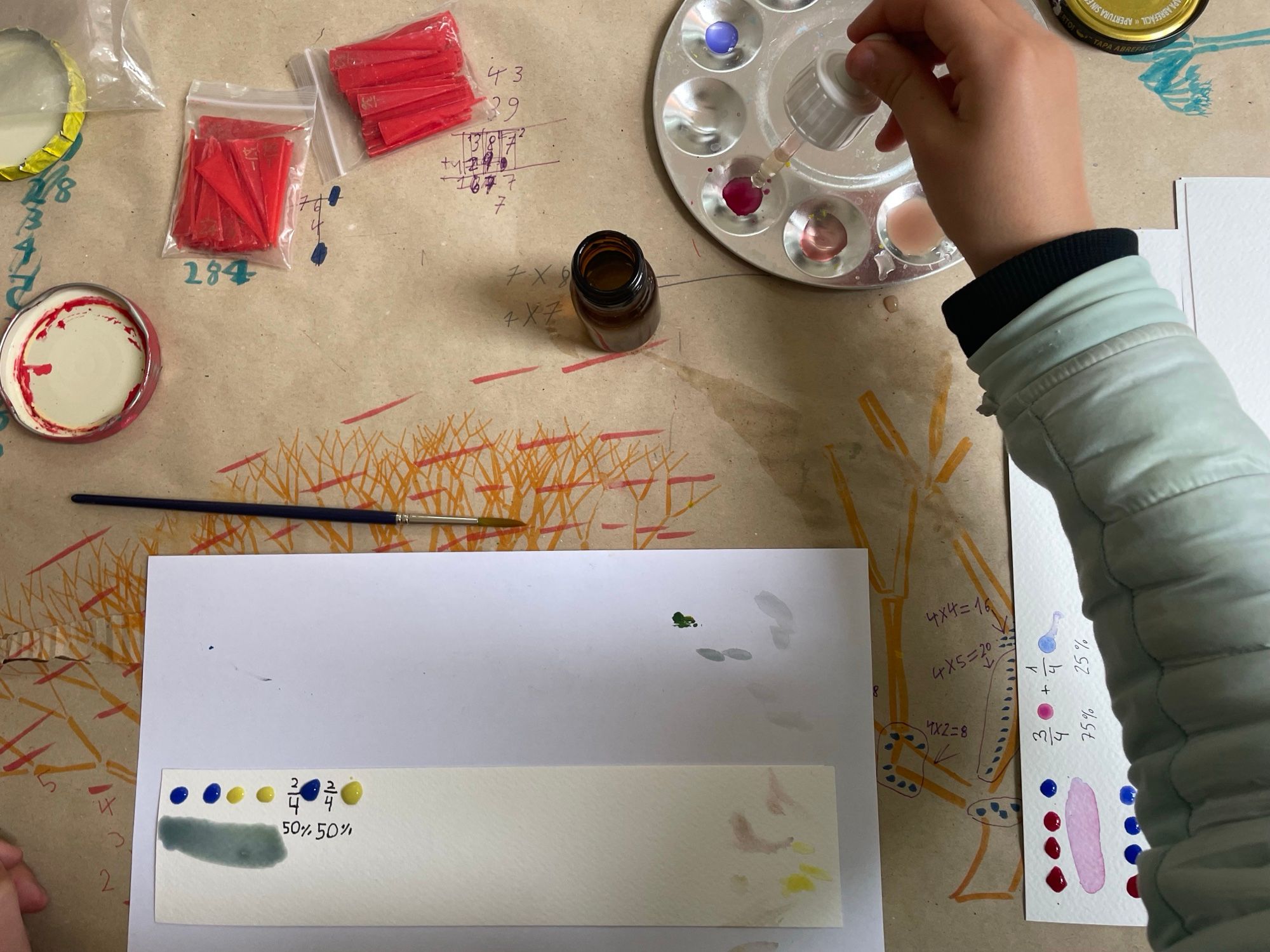 Mixing colours with a dropper: fractions and percentages written on the paper