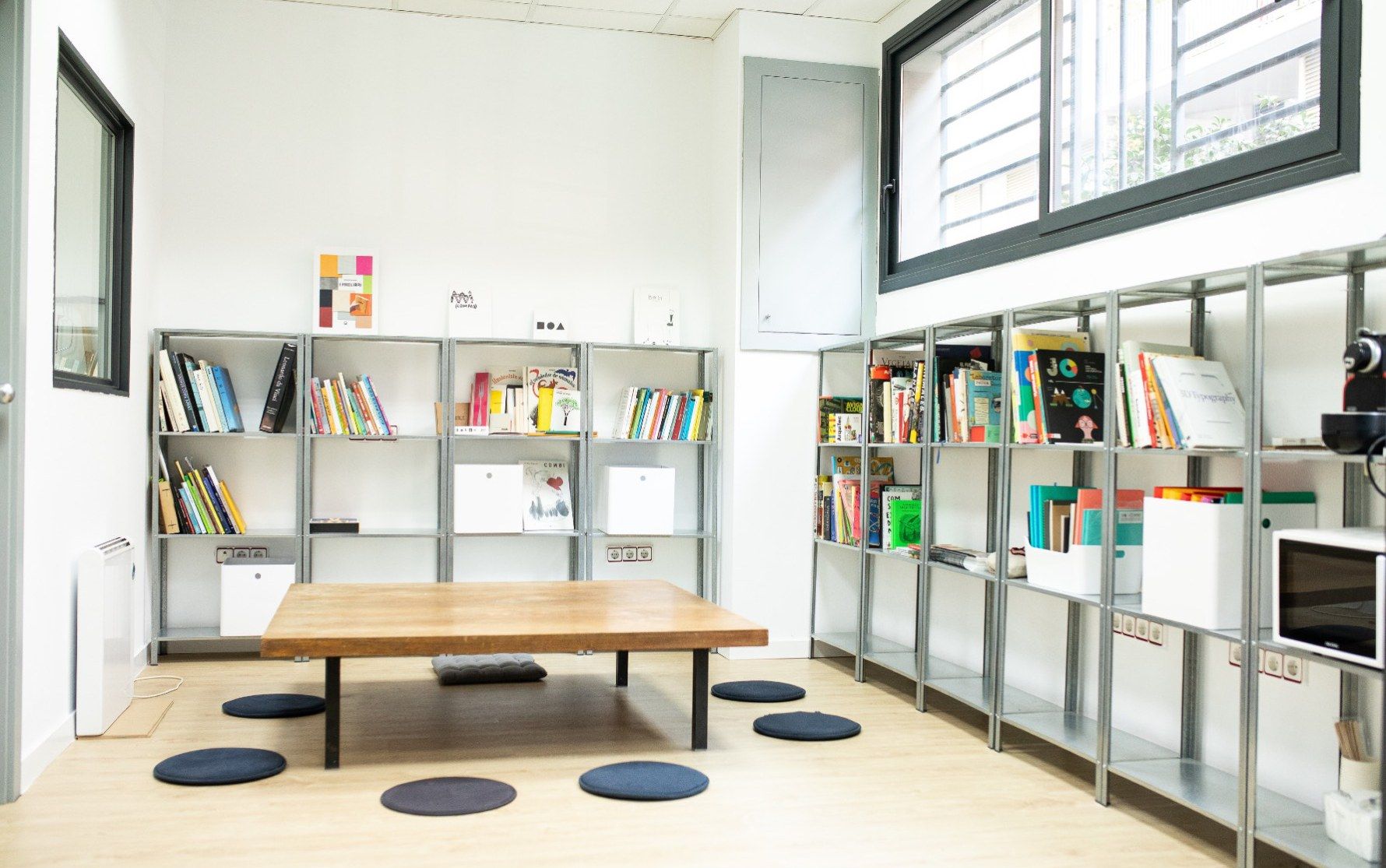 The Lab’s specialised library, with metal shelves and cushions on the floor
