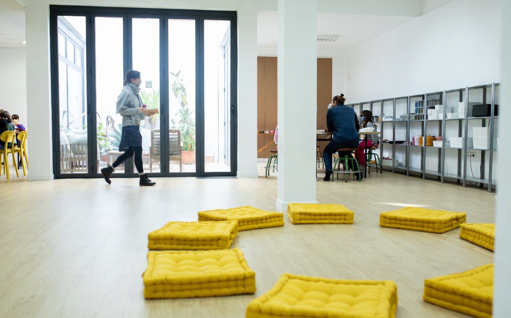 Lab room with yellow cushions and glass doors onto the courtyard