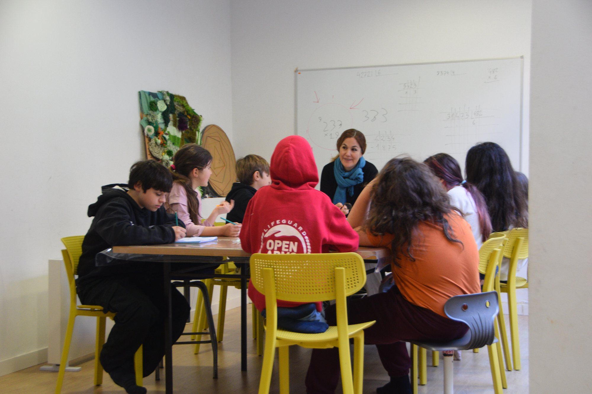 A primary group working at the table with their teacher